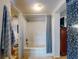 Bathroom with shower/tub combo and blue patterned curtain at 603 N Pine St, New Smyrna Beach, FL 32169