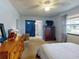Primary bedroom with ensuite bathroom and dresser at 603 N Pine St, New Smyrna Beach, FL 32169