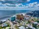 Aerial view of beachfront homes and a hotel, showcasing ocean views at 603 N Pine St, New Smyrna Beach, FL 32169