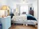 Bright bedroom featuring a king-size bed, ample natural light, and stylish decor at 603 N Pine St, New Smyrna Beach, FL 32169