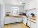 White kitchen with wood countertops and built in appliances at 603 N Pine St, New Smyrna Beach, FL 32169
