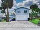 Two-story house with a detached garage and driveway at 603 N Pine St, New Smyrna Beach, FL 32169