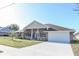 Brick ranch home with covered porch and attached garage at 243 Lagoon Mist Ct, Oak Hill, FL 32759