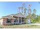 Brick ranch home with covered porch and attached garage at 243 Lagoon Mist Ct, Oak Hill, FL 32759