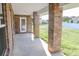 Covered back patio with brick columns and access to grassy backyard at 243 Lagoon Mist Ct, Oak Hill, FL 32759