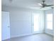 Spacious bedroom with plush carpet and exterior access at 243 Lagoon Mist Ct, Oak Hill, FL 32759