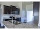 Modern kitchen with stainless steel appliances and granite countertops at 243 Lagoon Mist Ct, Oak Hill, FL 32759