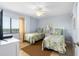 Bedroom with two twin beds, light blue walls, and ocean view at 4139 S. Atlantic Ave # B504, New Smyrna Beach, FL 32169