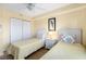 Bedroom with two twin beds, light yellow bedding, and ceiling fan at 4139 S. Atlantic Ave # B504, New Smyrna Beach, FL 32169