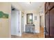 Bright condo entryway with mirror and coastal decor at 4139 S. Atlantic Ave # B504, New Smyrna Beach, FL 32169