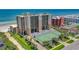 Aerial view showing building, tennis court, and oceanfront location at 4139 S. Atlantic Ave # B504, New Smyrna Beach, FL 32169