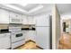 White kitchen with granite countertops and stainless steel appliances at 4139 S. Atlantic Ave # B504, New Smyrna Beach, FL 32169