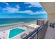 Ocean view from balcony showcasing pool and beach access at 4139 S. Atlantic Ave # B504, New Smyrna Beach, FL 32169