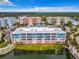 Aerial view of condo building, pool, and surrounding area at 1 Riverwalk Dr # 302, New Smyrna Beach, FL 32169