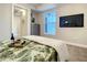 Bedroom with large TV and tropical bedding at 1 Riverwalk Dr # 302, New Smyrna Beach, FL 32169