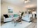 Spacious living room with coastal decor and balcony access at 1 Riverwalk Dr # 302, New Smyrna Beach, FL 32169