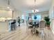 Open dining room with chandelier and view of kitchen at 1 Riverwalk Dr # 302, New Smyrna Beach, FL 32169