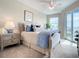 Bedroom with window, ceiling fan, and neutral decor at 1 Riverwalk Dr # 302, New Smyrna Beach, FL 32169