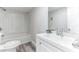 Clean bathroom with white vanity, tub, and shower at 1355 Powers Ave, Daytona Beach, FL 32117