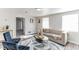 Living room with beige sofa, blue chairs, and wood floors at 1355 Powers Ave, Daytona Beach, FL 32117
