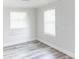 Bright bedroom with two windows and wood-look floors at 1355 Powers Ave, Daytona Beach, FL 32117