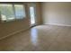 Living room with tile floors, large window, and glass French door at 4513 Saxon Dr, New Smyrna Beach, FL 32169