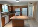Kitchen boasts wood cabinets, tiled floors, and an island at 4513 Saxon Dr, New Smyrna Beach, FL 32169