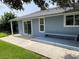 Home features a backyard patio with a concrete slab and wooden bench at 4513 Saxon Dr, New Smyrna Beach, FL 32169
