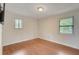 Bedroom with hardwood floors and two windows at 6468 Engram Rd, New Smyrna Beach, FL 32169