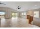Spacious living room with vaulted ceilings, tile floors, and sliding glass doors leading to a deck at 6468 Engram Rd, New Smyrna Beach, FL 32169