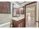 Clean bathroom with dark wood vanity and a view to another room at 6468 Engram Rd, New Smyrna Beach, FL 32169