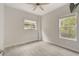 Spacious bedroom with two windows and ceiling fan at 6468 Engram Rd, New Smyrna Beach, FL 32169