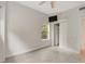 Bright bedroom with tile floors, window, and closet at 6468 Engram Rd, New Smyrna Beach, FL 32169
