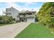 Two-story house with light blue siding, a large deck, and a spacious driveway at 6468 Engram Rd, New Smyrna Beach, FL 32169