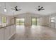 Open concept kitchen with granite countertops, stainless steel appliances, and white cabinets at 6468 Engram Rd, New Smyrna Beach, FL 32169