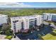 Aerial view of a condo building with lush landscaping and water views at 5300 S Atlantic Ave # 6-505, New Smyrna Beach, FL 32169