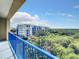 Enjoy a scenic view of lush greenery and nearby buildings from this condo balcony at 5300 S Atlantic Ave # 6-505, New Smyrna Beach, FL 32169