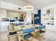 Spacious dining area with glass table and blue and white striped chairs at 5300 S Atlantic Ave # 6-505, New Smyrna Beach, FL 32169