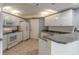 Well-equipped kitchen featuring white cabinets and granite countertops at 5300 S Atlantic Ave # 8502, New Smyrna Beach, FL 32169