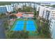 Aerial view of tennis courts and resort-style pool at 5300 S Atlantic Ave # 8502, New Smyrna Beach, FL 32169