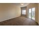 Bright bedroom with balcony access and neutral carpeting at 5300 S Atlantic Ave # 8502, New Smyrna Beach, FL 32169