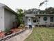 House entrance with walkway and well-maintained landscaping at 806 E 2Nd Ave, New Smyrna Beach, FL 32169