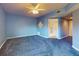 Blue bedroom with carpeted floor, ceiling fan, and access to a bathroom at 5300 S Atlantic Ave # 9201, New Smyrna Beach, FL 32169