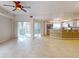 Spacious living room with tile flooring, sliding doors to balcony, and kitchen at 5300 S Atlantic Ave # 9201, New Smyrna Beach, FL 32169