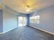 Blue bedroom with balcony access, carpeted floor, and ceiling fan at 5300 S Atlantic Ave # 9201, New Smyrna Beach, FL 32169