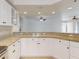 Kitchen with granite countertops, white cabinets and stainless steel appliances at 5300 S Atlantic Ave # 9201, New Smyrna Beach, FL 32169