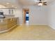 Open living and kitchen area with tile floor and access to balcony at 5300 S Atlantic Ave # 9201, New Smyrna Beach, FL 32169