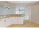Bright kitchen with granite countertops and white cabinets at 5300 S Atlantic Ave # 9201, New Smyrna Beach, FL 32169