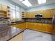 Community kitchen with granite countertops and wood cabinets at 5300 S Atlantic Ave # 9201, New Smyrna Beach, FL 32169