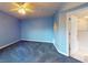 Blue bedroom with carpeted floor, ceiling fan, and access to a bathroom at 5300 S Atlantic Ave # 9201, New Smyrna Beach, FL 32169